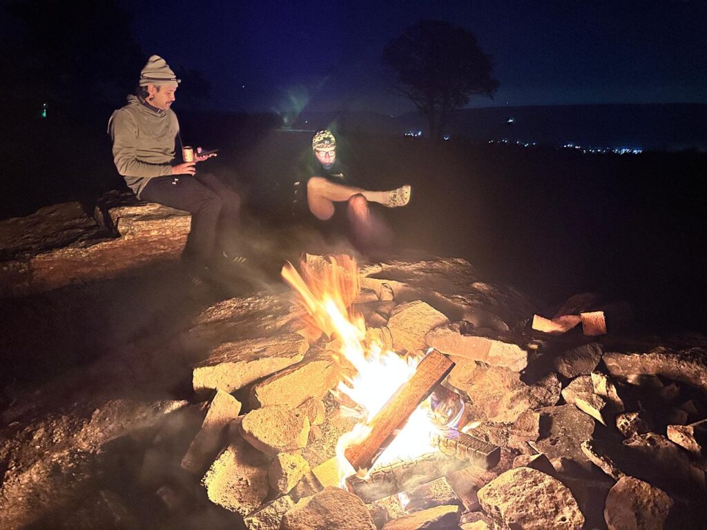 Photo of riders next to campfire